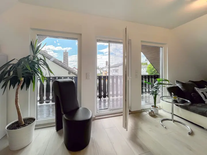 Living and dining area with large balcony windows