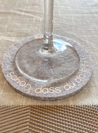 Decorative detail beneath a wine glass on the dining table