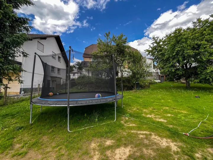 Large garden with trampoline and lawn